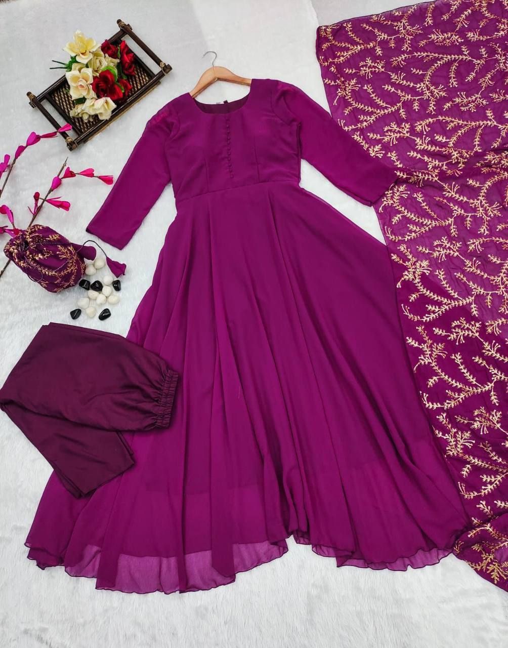 TRADITIONAL ANARKALI PAIRED WITH A EMBROIDERED DUPATTA AND A POTLI BAG